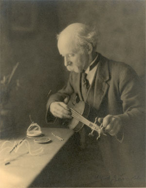 Alfred tuning a violin