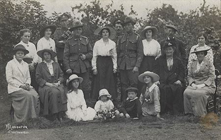 Two Australian soldiers posse with a group Two Australian soldiers posse with a group